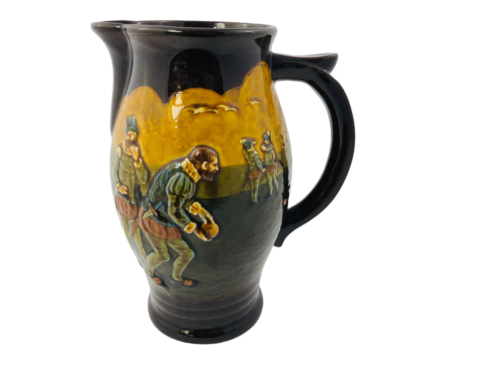 Ceramic pitcher with artistic depiction of figures on a white background